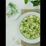 Cristina Ferrare Instagram - I love the summer month of August! The garden is bursting with veggies and herbs. One of my favorite things to make is cucumber & Zucchini Carpaccio Salad, it’s a hit with everyone. If you don’t grow your own veggies please try the organic veggies at your local open famers market or a super market that carry organic produce. Enjoy:) 1/4 cup extra-virgin olive oil 4 Tablespoons fresh lemon juice 1 Tablespoon seasoned rice wine vinegar 1 Tablespoon finely chopped fresh mint 2 teaspoons finely chopped fresh dill 1 Tablespoon finely chopped Italian parsley 2 zucchini sliced paper-thin 2 cucumbers sliced paper-thin 1/4 teaspoon kosher salt 1/2 cup feta cheese, crumbled 1/4 cup finely chopped roasted walnuts Freshly cracked pepper In a glass bowl, whisk together the olive oil, lemon juice, vinegar, mint, dill, and parsley. Set aside. Slice the vegetables on a mandolin or a vegetable slicer that can slice paper-thin. Arrange the zucchini and cucumbers alternately on a large platter. Sprinkle lightly all over with kosher salt. Drizzle 3 tablespoons of the vinaigrette over the top, add the crumbled feta, and sprinkle with walnuts and cracked pepper to taste, If you are not going to use the salad right away, do not add the vinaigrette; instead, cover with plastic wrap and refrigerate until you are ready to serve. Enjoy the rest of summer! :) P.S. Coconut cake is coming next week:)! I #summer #summersalad #family #summer #salad #healthysalad #organic #organicfoods #eatorganic #gardenvegetables