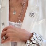Cristina Ferrare Instagram - I received many inquires about the beautiful suit I wore to the "The Race to Erase MS” event founded by one of the most inspirational women I know @nancydavis! Also, evidently my over the top Swarovski Crystal cuff caught everyone’s eye!! and the tiny medallion I wore around my neck and it’s meaning. The beautiful suit I wore is from, @cinqasept whose founder and CEO is Jane Siskin. We were treated to a sneak peek of their new spectacular collection! People were literally stopping me to tell me how beautiful my suit was! The whole evening was devoted to raising funds to continue finding new drugs and a cure for MS! Thank you Nancy and congratulations on the 30th anniversary of raising millions of dollars to make a difference in people’s lives with MS! The Cuff was made and designed by Tim Hosier. He and his partner@brianthorson own a beautiful home decor store in Palm Springs, @marquettehome. The one that emotionally touches my heart is the little medallion I wear around my neck. Many people asked me the meaning behind it. I have not taken it off ever since my daughter @ariannasalyards_ put it on me. She created the pendant after suffering 3 pregnancy losses. She wanted something tangible to hold as she could only hold her babies in her heart. It is for her a symbol of hope. Part of the proceeds from the sale of the necklace go to continuing the work of advocacy, access to care, education , awareness and community support! If you know of anyone who is going through IVF or infertility issues You can find the necklace @silpadadesigns Thank you Nancy, Jane and Arianna, women making a difference!!❤️