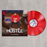 Dan Deacon Instagram - HUSTLE soundtrack is now available on vinyl in editions of BLUE vinyl and a forthcoming RED vinyl. Link in bio to order now! Info from the press release: (June 23, 2022 – Los Angeles, CA) – Netflix and Diggers Factory are excited to announce the release of the Hustle (Soundtrack from the Netflix Film) LP with music by composer Dan Deacon. The soundtrack is available now for pre-order on Diggers Factory and comes pressed on blue vinyl, with a red version coming later from the Netflix Shop. Adam Sandler’s Hustle debuted on Netflix's English Films list at #1 with 84.58M hours viewed and climbing. With a Rotten Tomatoes score of 92% from critics and 92% with audiences, the film has been getting rave reviews.