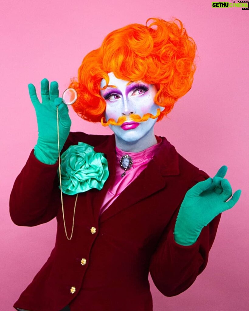 Daniel Wallace Instagram - Check out this gorgeous shot of me wearing a fancy new wig and tasche by the incredibly talented @florencias_wigs (I hear there will be a range available soon!) by @faketrashstudio 💗 Playing at being an effeminate gentleman and wearing my green carnation so everybody knows it 😂 #christmas #Greencarnation #Victorian #orange #moustache #Drag #Manchesterqueen #manchesterking Islington Mill