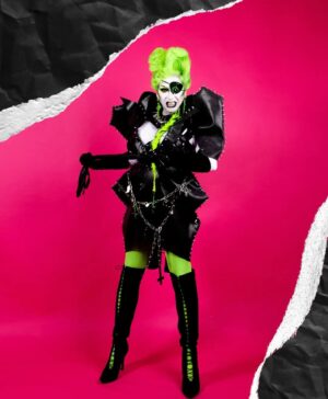 Daniel Wallace Instagram - Monsters of Rock part 1
For this floorshow we had to create a monsters of Rock look that would read in an arena(big hair big silloutte)I'm not particularly a 'Rock' gal but felt I really had to rise to this challenge(especially after all the drama in the show)
I needed battle armour.I wanted big armour like shapes similar to Gwar but also wanted a vampire /villainy edge.
Hence the coffin shaped shoulders and upside down crucifix details and eyepatch.
Inspo's were obviously drawn from punk(I love the creativity of The Blitz kids from 80's and the ability to create something from nothing)
The outfit was made by the glorious @punkmukeee out of (roofing material?)found in our art studio's and nuts and bolts!🖤
@florencias_wigs on hair and killer ponytail with spikes 💚
Crosses and earrings @shopfairlyodd 🤍
Photo by @Faketrash 💗
Chains 
#Monstersofrock #Dragula #neon #Manchesterqueens