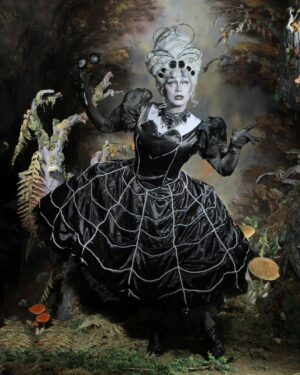 Daniel Wallace Instagram - Will you walk into my parlor?” said the spider to the fly;
“’Tis the prettiest little parlor that ever you did spy.
The way into my parlor is up a winding stair,
And I have many pretty things to show when you are there.”
Wearing @florencias_wigs and @lizziebiscuits shot by @neilnezkendall 🖤#hypnotic #spiderweb #wood #timburton #dark #gothic #fairytale #drag #manchesterqueens #dragqueen