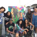 Donisha Rita Claire Prendergast Instagram - #wewillrizetogether team is growing by leaps and bounds. @thekayafest has created the space for #wewillrizetogether 💜 @komiolaf will be finishing this live painting and it will be auctioned at The Black Star Party on Monday April 30 at Los Globos. Big Love to @machelmontano for passing through and putting your mark on the painting #kayafest2018 Kaya Fest