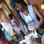 Donisha Rita Claire Prendergast Instagram - Reminder to self: We must Rebel against any system or structure which distracts and misinforms our youth. One of the most liberating moments for me this week on the We Will Rize Together project at the Haile Selassie High School, was working with a bunch of youth from the Payne land community who came to volunteer, and see what little treasures they could find. I explained that we were fixing the library and saving some books, but some would be destroyed. I wanted to be clear with them that books aren’t garbage, but there is great symbolism in tearing up and discarding a bunch of old, outdated neo-colonial literature. The kind that teaches our children how to grow cotton, and others with images that portray the Africans who were stolen and sold into slavery as savage and backward. Books that have done nothing to empower I&I sense of self. @ms_laurynhill song ‘I find it hard to say...Rebel’ kept repeating loud in my head. ‘I find it hard to say that everything will be alright. Cause my own eyes can see through all your false pretenses. As history repeats so foul that you can taste it.... We must destroy in order to rebuild. Wake up! You might as well. Or are you satisfied? Are you satisfied?... Rebel!’ Until the curriculum reflects more about who we are and all the things we have been, we will never be who we are supposed to be. A people without the knowledge of their past history and culture is like a tree without roots Garvey says. I’m still writing this message in English, the language of the colonizers. The second language I was taught in school is Spanish, because Colombus and his friends never really left Jamaica. I don’t know my Mother tongue, or which village in which country in Africa my ancestors came from. I’m still fighting to remember all the things they wanted us to forget. Why don’t you Rebel?.., Or are you satisfied? #miseducation #liberation #africandiaspora #createclassroomseverywhere #emancipation #rightyourstory #wewillrizetogether #Buildcomeunity #dobetter