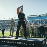 Dwayne Johnson Instagram – Microphone in hand. 
100,000+ strong. 
Live as the world watches. 

This is heaven. 
I’m a grateful I get to do crazy stuff like this. 

“In the proud spirit of America 
In the proud spirit of our great country 
FINALLY, The Rock says 
Drivers start your engines” 

#Daytona500
#GrandMarshall 
#PeoplesChamp 
@nascar 
@daytona

📸• @thisisamandaw