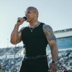 Dwayne Johnson Instagram – Microphone in hand. 
100,000+ strong. 
Live as the world watches. 

This is heaven. 
I’m a grateful I get to do crazy stuff like this. 

“In the proud spirit of America 
In the proud spirit of our great country 
FINALLY, The Rock says 
Drivers start your engines” 

#Daytona500
#GrandMarshall 
#PeoplesChamp 
@nascar 
@daytona

📸• @thisisamandaw