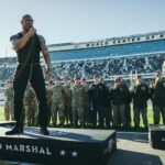 Dwayne Johnson Instagram – Microphone in hand. 
100,000+ strong. 
Live as the world watches. 

This is heaven. 
I’m a grateful I get to do crazy stuff like this. 

“In the proud spirit of America 
In the proud spirit of our great country 
FINALLY, The Rock says 
Drivers start your engines” 

#Daytona500
#GrandMarshall 
#PeoplesChamp 
@nascar 
@daytona

📸• @thisisamandaw
