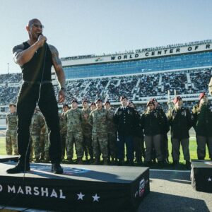 Dwayne Johnson Instagram - Microphone in hand. 
100,000+ strong. 
Live as the world watches. 

This is heaven. 
I’m a grateful I get to do crazy stuff like this. 

“In the proud spirit of America 
In the proud spirit of our great country 
FINALLY, The Rock says 
Drivers start your engines” 

#Daytona500
#GrandMarshall 
#PeoplesChamp 
@nascar 
@daytona

📸• @thisisamandaw