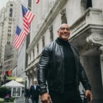 Dwayne Johnson Instagram - From $7 bucks to this surreal day. Crazy. Thank you @nyse for the incredible & very warm welcome. Honored to join the Board of Directors for @tkogrp and honored to ring the iconic bell to open our market. Let’s get to work. @wwe @ufc #peopleschamp @thisisamandaw 📸