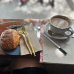 Ella Hooper Instagram - I found a VERY ‘me’ little cafe in Darwin and have had about 40 flat whites here in 48hrs.. Gahh. I’m a sucker for the rare comfortable, cosy, textured, down to earth, GREAT QUALITY coffee/food but non-fussy environment/attitude places! I fear sadly they are almost gone from Melbourne. I sooo miss the old cafes of st Kilda and Fitzroy that had exactly THIS kinda charm. THAT’S what I thought cafes would be when I was a kid. Places where you could stare at a wall for hours and there would actually be something to look at, get lost in? Other than just packets of coffee and coffee making equipment. Yes I know I’m in a place of coffee making guys. But are cafes not for daydreaming? Killing time? I’ve always used them that way. Now it’s take aways on the hop or laptops out and down to bizznizz. I absolutely partake of (regularly) these more polished, precise roasted on-site, uber technical but somewhat vibe-less (unless you’re a 100% coffee snob who is THRILLED by talking about, reading about DEEP DIVING coffee beans and blends and brewing techniques .. 🥱 ((just kidding thank you for your hard work!! Coffee is mostly delicious these days thanks to you people!!)) But what about the poetry of the cafe? Dare I say the vibe? Is it dying? Can we maybe have a lil return to less clean as whistle white monogrammed you bought the cuppa now buy the t-shirt model back to the cosy old bolt hole style? I’m ready for it. Call me an old bohemian or bohemian wannabe. I probably am! Child of the 90’s an all that. 💁🏻‍♀️☕️ Anyway! LOVE your work @the1995darwin - please open a Melbourne sister store Xx #franchise #coffeethinkin #caffeinedrinking #jest #ilovebaristas #donthateme #iloveALLcafes