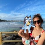 Ellie Taylor Instagram – Took a break Down Under with my little Bluey. A beaut of a trip full of sun, sea, delicious egg & bacon rolls, excellent margs and some bloody bonza Sheilas/Bruces. 

However I can’t pretend I don’t have concerns about something I witnessed first hand over there which I found incredibly worrying. An issue which is blighting the gorgeous homeland of my husband. And that is what I can only describe as a MULLET EPIDEMIC. They are everywhere. EVERYWHERE. I even saw a few toddler aged kids with them. No irony there. Just some little boys eating sand on the beach whose parents CHOSE for them to look like 1989 Andre Agassi. 🤯