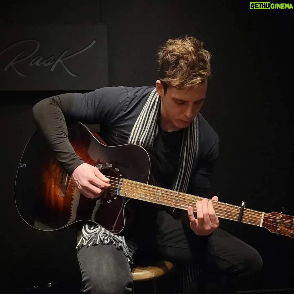 Eric Osmond Instagram - Throwback to some amazing memories with @raskguitars and the gang! 😍🎸 Their craftsmanship and innovation in creating unique guitars, using ancient materials, is truly awe-inspiring. The sound that resonates from their guitars is unparalleled and unlike anything you may have heard before! 🔥 I'm still blown away by the phenomenal sound and quality. If you're a music lover or a guitar enthusiast, you definitely need to check out @raskguitars to experience for yourself the magic they create. Can't wait to see what they come up with next! 🤩🎵 🎸 💡 Crazy idea... what if Robert were to let me use a Rask Guitar to record an acoustic version of my new song "Begin Again" (coming out on April 21st)! What do you think? Should I reach out to Robert Rask and see if we can make this happen? 😉 Fun Fact: When I first picked up a guitar, my very first jig was fiddling around on the high E string and trying to sound out the iconic theme song for Top Gun  ("Top Gun Anthem" by @haroldfaltermeyer) lol I'm sure you can hum it right now without even hearing it, it's that iconic. 🎶😄 Music seems to leave a unique memory, so when you hear an old song an entire of your life can emerge in moments for you. What song(s) do that for you? Do they make you want to... "Begin Again"?  💪🎶😁😉 #uniqueguitar #ericosmondmusic #newmusic #acousticguitar Rask Guitars