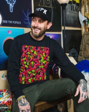 Geoff Ramsey Instagram - If you want to look as happy as I’m pretending to be in this pic, maybe buy a shirt. Or whatever. I don’t know. I’m not your dad. Link in bio. Photo by @atwes