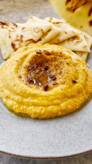 Gordon Ramsay Instagram - Autumn is in the air and this delicious squash hummus recipe is the perfect dip for the weekend or watching any sporting event ! 
.
Cinnamon
Cloves
Coriander seed
Fenugreek seed
Fennel seed
Mustard seed
Cumin seed
Butternut Squash
Garlic
Ginger
Olive oil
Tahini
Chickpeas
Lemon
Kosher salt
Pita, for serving