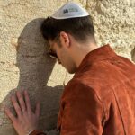 Gregg Sulkin Instagram - Returning to the Western Wall, years after my Bar Mitzvah, I felt a profound connection to my heritage. Standing here, I am reminded of the enduring spirit and resilience of the Jewish people. In the shadow of these ancient stones, I reflect on our everlasting prayers for peace. Proud of my roots, humbled by our history, and committed to a future where peace reigns supreme. Western Wall Jerusalem