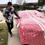 Gus De St. Jeor Instagram - My bros gave me a nice Christmas wrap for the holidays... what do you guys think? 👀🎁 Go check the link in my bio to see my first reaction