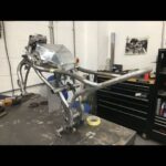 Guy Martin Instagram - During Lockdown Guy has managed to keep himself busy with work on the tractor, a filming job for the new year, PROJECT300 and of course lots of jobs on in the shed. He also however found time to lend his knowledge and experience to a new but old venture. Doctor Tony Keating from @keatingsupercars and Bolton University NCME National Centre for Motorsport Engineering, Gary Hewitt and Ian Martin from ELAS and owners of the Dot brand have decided to bring life back to a historic British motorcycle, Dot. Gary and Ian are long time personal sponsors of Guy, naturally they asked Guy for his input. Over the past few months Dr Keating and his team have developed and manufactured a cafe racer style motorbike and Guy has had an eye on the project from the start, giving them valuable advice on set up and style. Dr Keating and his team will be ready in the not to distant future to reveal DOT in all her glory. @dot.motorcycles