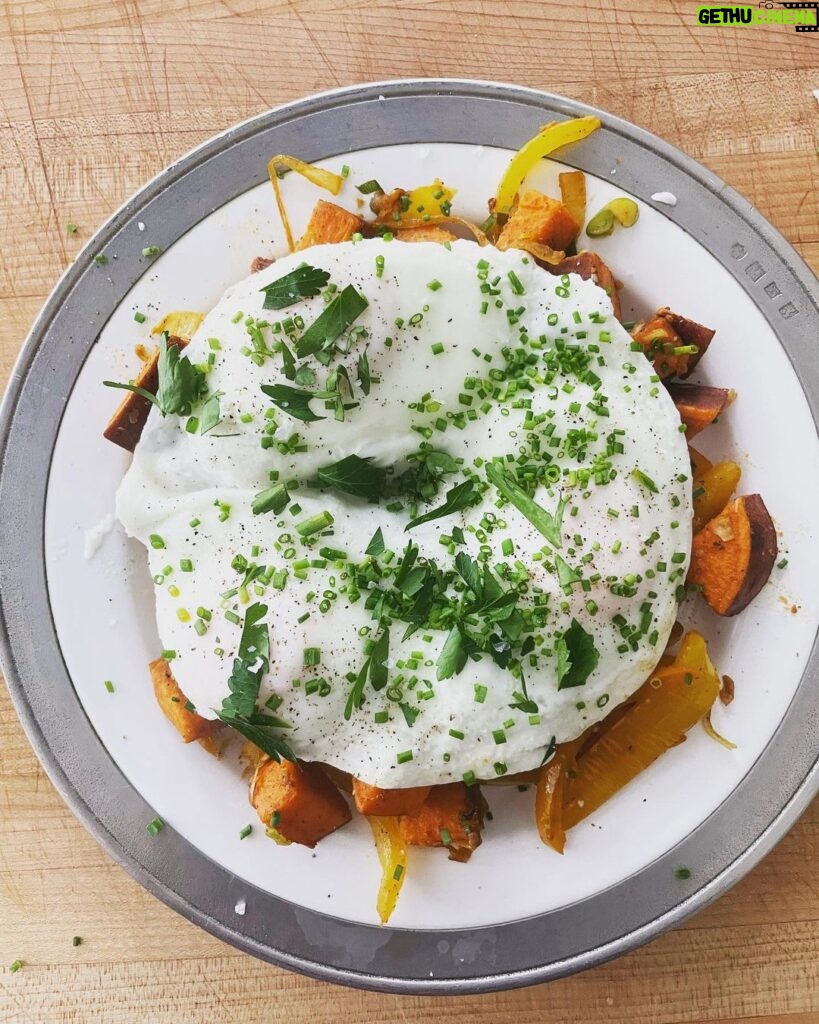 Gwyneth Paltrow Instagram - #boyfriendbreakfast today was an easy sweet potato hash. Sweat some onions Add some bell peppers and let caramalize about 10-15 mins Cube and boil sweet potatoes in salted boiling water about 10 mins and let steam and dry in the colander when ready Add garlic and cook with the peppers and onions Add sweet potatoes, some paprika and chili powder to taste Add scallions and cook for a few to let all flavors combine Fry your eggs adding water, my new favorite trick Season and add something green, I had parsley and chives so I went with that #paleo