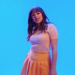 Hayley Orrantia Instagram - Open Your Mouth official music video is out now!!! 💋 Going live on Tiktok to discuss the process with Greg at 5 PM PST today! • • • Directed by @thegregfurman Produced by @hayleyorrantia Starring @jt_neal Hair: @stuntzbeauty Makeup: @antonmakeup Styling: @stylelvr