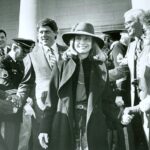 Hillary Clinton Instagram - I love summer, but here's to the beginning of trenchcoat season! #tbt⁣ ⁣ Photo: Clinton Foundation⁣