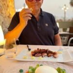 Hugh Wallace Instagram - Thank you for all your recommendations. Here’s a round up of the places that we would recommend to eat in Sitges. Best main fish dish Toni’s Bistro. La Pou, smoked aubergine with cream cheese, honey and crushed nuts, a twist on tapas. Perfect Scallops at Fragata, with a great terrace to watch the world go by. La Cocina one of the best restaurants in town, make sure you book. Lobster ravioli at Marciel on the waterfront was amazing. @restaurantemaricel Snails with lobster in a Catalonia style at La Nansa, wonderful staff & the best dark & white chocolate desert which was eaten by Martin before I could get a photo! #food #restaurant #holiday Sitges, España