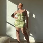 Iskra Lawrence Instagram - Mama is off to Miami this weekend for a bachelorette with 16 baddies… it’s about to be carnage🥵 until 11pm because - bedtime. so it’ll be sensible carnage and lots of reading books on the beach🫠 Photo description #accessibility : [Iskra is statuesque standing against her wall with golden hour sunlight pouring through the windows on her glowing skin. Wearing a mint green satin mini dress, with a clear gold Perspex handbag and gold strappy stiletto heels embodying the slayage] Miami, Florida