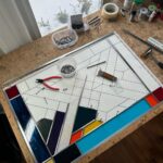 Ivy Winters Instagram - Hello everyone! I hope everyone has been staying happy and healthy this winter season!I’ve been pretty busy making stained glass panels and wanted to share with you my latest commission piece. It’s 31” by 21” with a fun range of colors, textures and square bevels. It has been recently installed in my clients laundry room (last picture). #stainedglass #leadwindow #lead #glass #glasscutter #beveledglass #art #window #handmade