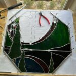Ivy Winters Instagram - I had a fun time making this northern lights window for my folks house. Each beveled star represents a direct member of our family. So happy how it fit right into the octagon frame as this was my first octagon window! Jamin out to #gilbertosullivan #stainedglass #leadedwindow #forrest #northernlights #antiqueglass