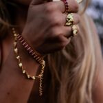 Jessica Lord Instagram - Introducing the JOCELYN. Perfect for the holidays, our cherry wine red stone bangle, with its bold hue and 18k gold plating, is a declaration of strength and passion. It’s a piece that resonates with the fire within every woman. Pair with our matching CEILIDH ring for the ultimate celebration of passion, sensuality, and the wild nature of a fiery spirit. These pieces complement each other flawlessly or serve as individual statement pieces, adding a touch of vibrant color to spice up your life. Don’t miss out on the captivating Jocelyn and Ceilidh pieces, waiting for you at Bizouxx.com 🖤