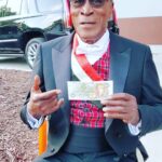 John Amos Instagram - BTS On The Set of Coming 2 America! My Manger @paulyfilms00 captured me having fun with some of Akeem’s Money! C2A Streaming Now on @amazonprimevideo ! -J.A.