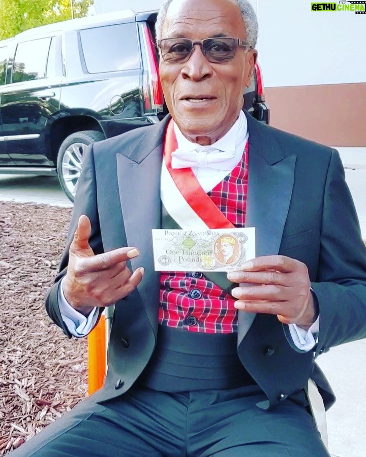 John Amos Instagram - BTS On The Set of Coming 2 America! My Manger @paulyfilms00 captured me having fun with some of Akeem’s Money! C2A Streaming Now on @amazonprimevideo ! -J.A.