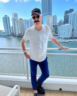 John Cleese Instagram - Yes, I’m wearing a shirt with my face on it. You can too! Click the link in my profile or go to bit.ly/cleesemerch to see all the designs! 🥸 

#johncleese #johncleesetour #lasttimetoseemebeforeidie #bighead #malemodeling