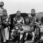 John Cleese Instagram - Cold, rainy, chilly, wet and about four umbrellas between the whole cast and crew. 49 years ago today. #montypython #montypythonandtheholygrail #filmhistory #chainmail #behindthescene