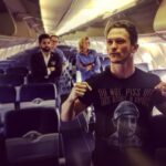 Jonathan Tucker Instagram - "we flying the first class up in the sky. poppin' champagne. living my life in the fast lane & i won't change for the glamorous." -lowkey lyesmith (from seat 26b with a layover in el paso) BUY SHIRT TO SUPPORT THE PEGASUS FUND. LINK IN BIO. #americangodsstarz El Paso International Airport (ELP)