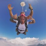 Josh Dun Instagram – in the sky, with some guy, and a tiny looking parachute.