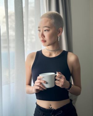 Julie Tan Instagram - Flaunting my fresh blonde buzzcut and pretending this cup isn’t just a prop to show off my nails. 🤫