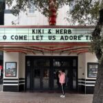 Justin Vivian Bond Instagram - Honored guests in Austin: @worldfamousbob and her beautiful family. @kennymellman beneath the marquee of the @paramountaustin, some creepy baby clothes at the truck stop on the was from Dallas. 6 shows down, 2 to go! See you tomorrow in San Francisco at the @the_castro_theatre, then Saturday in LA at the @thewiltern. 🩷 Paramount Theater, Austin, Tx