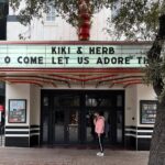 Justin Vivian Bond Instagram – Honored guests in Austin: @worldfamousbob and her beautiful family. @kennymellman beneath the marquee of the @paramountaustin, some creepy baby clothes at the truck stop on the was from Dallas. 

6 shows down, 2 to go!

See you tomorrow in San Francisco at the @the_castro_theatre, then Saturday in LA at the @thewiltern. 🩷 Paramount Theater, Austin, Tx