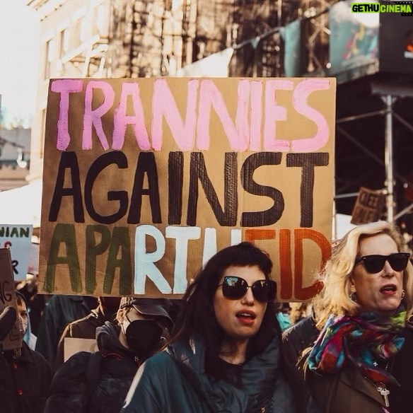 Justin Vivian Bond Instagram - Trans Awareness Week We weren’t aware that sign was behind us or that we were being photographed at the Queer Solidarity March yesterday but we aren’t mad at it. Sending love and solidarity to all my trans siblings from the US to Gaza, Ukraine and throughout the world who are fighting and living bravely despite anti-trans laws, injustice, wreckless patriarchal violence, extremist ideologies, gender essentialism, and genocide. We always have and always will prevail. #glamourisresistance #transawarenessweek #ceasefirenow #transisbeautiful 🩷🤍🩵 Photo: @alexabwilkinson