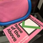 Justin Vivian Bond Instagram - When the world gets ugly match your literature to your handbag. This revolutionary book by @travisalabanza is turning me out! It’s like one of the best self/help books that puts words to something you feel deep inside your bones. Once you read it you feel liberated and that much more whole. Love you Travis. 💞 That beautiful pink bag by @jw_anderson @jonathan.anderson speaks for itself. Wearing it not only cheers me up, but based on all the compliments it receives, it cheers other people up too. #glamourisresistance #keepitprettykeepitshallowkeepitmoving #gendertranscender