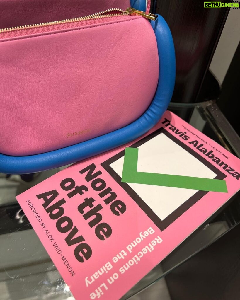 Justin Vivian Bond Instagram - When the world gets ugly match your literature to your handbag. This revolutionary book by @travisalabanza is turning me out! It’s like one of the best self/help books that puts words to something you feel deep inside your bones. Once you read it you feel liberated and that much more whole. Love you Travis. 💞 That beautiful pink bag by @jw_anderson @jonathan.anderson speaks for itself. Wearing it not only cheers me up, but based on all the compliments it receives, it cheers other people up too. #glamourisresistance #keepitprettykeepitshallowkeepitmoving #gendertranscender