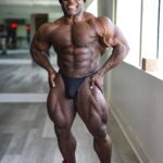 Kai Greene Instagram - Which Pose?! 1 or 2 💪🏾 When we're ever feeling stuck the best thing we can do is start. Success, results, and the whole process in between doesn't happen overnight. Instead, it is the result of small steps taken every day. And when you take these steps repeatedly, you learn how to tap into your potential. When it comes to creating more power and control from the ground up, nothing compares to @ryderwear D-MAKs! The trusted shoe to get your feet as close to the ground as possible, maintaining balance and stability in a way that many other shoes simply can't. Lace up a pair today and experience strength in numbers! #KaiGreene #Ryderwear Redcon1 Gym