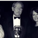Kate Beckinsale Instagram – Here is a photo just after I presented my stepdad with the lifetime achievement Alan Parker Special Award BAFTA for his incredible work as a director in television from Colin Welland’s “Leeds United!” about the first all female strike in the clothing trade ,”Roll on Four o clock “, the documentary “The Body” with music by Roger Waters and commentary by the poet Adrian Mitchell , the first seven episodes of the ground breaking “Tomorrow’s World”to Cracker,Between the lines, Inspector Morse, King of the Ghetto starring a very young and very brilliant Tim Roth,A Touch of Frost ,the first and only Edward Bond play ever written for television starring Bernard Hill and the late , mesmerising Charlotte Coleman and countless others . Today BAFTA told me they ‘could not guarantee’ he would be included in their “in memoriam” tribute , to honour the industry members we have lost . So a man dead less than a week somehow has to audition in front of a committee after a decades long career (in which he has been awarded from said organisation the highest accolade they have ) to decide IF his death is worth mentioning . If his work, his life ,his craft ,his mentoring , his heart and soul are worthy of a mention that he is gone . That , that has broken my heart all over again . I am paralysed ,sick and sickened and I will honour him and his work every day of my life . ***Oh and while I am at it, yes it is my mum briefly in the Netflix show Fool me Once, for those who asked . And she has been gracefully and quietly dealing with stage four cancer for the last six years and just lost her husband so thanks again , BAFTA for your horribly cold email.