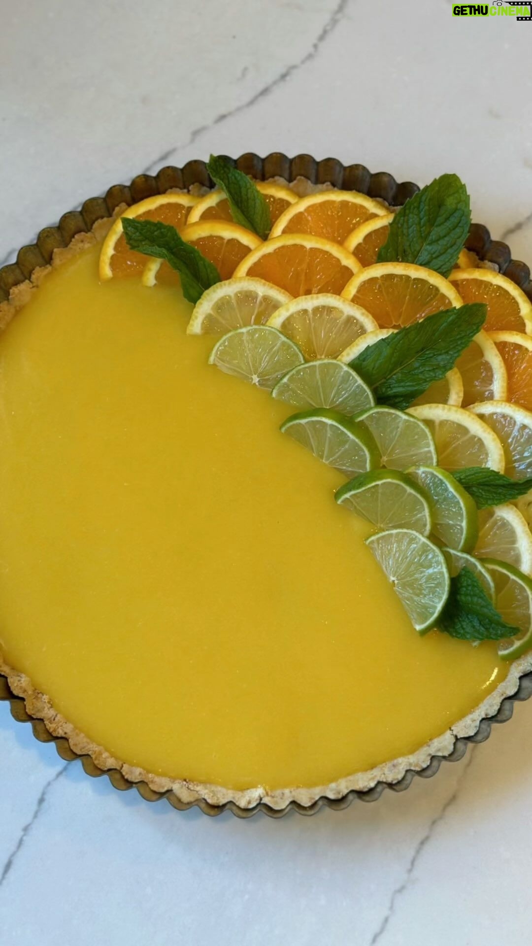 Kate Hudson Instagram - A Sicilian Lemon Tart featuring the limited-edition spatula I designed with Rani Rose for @nokidhungry x @williamssonoma! 🍋💛 Help end childhood hunger in America by purchasing one using the link in my bio. Each spatula purchased can help provide 40 meals for kids and teens! Recipe below👇 Crust: 1/4 cup olive oil 1 1/2 Tbsp Ground Almonds 1 1/4 cup all-purpose flour 1/4 vanilla bean sea salt 1 egg yolk Custard: Juice of 3 lemons Zest of 1 lemon 6 oz. Cane sugar 2 Tsp cornstarch 2 egg yolks 2 whole eggs 2 oz of unsalted butter, cubed 2 Tbsp olive oil 1. Mix all ingredients for the crust in a bowl. Should be crumbly, but come together, 2. Press into the tart pan and bake at 350F for 15 mins. Let cool while you work on the custard. 3. Combine all ingredients for the custard in a medium sauce pan, EXCEPT FOR olive oil and butter, on medium heat. Stir until thickened. 4. Remove mixture from heat then stir in olive oil and butter until melted. 5. Pour the custard mixture onto the tart crust. 6. Refrigerate for 2-3 hours. Garnish with fresh citrus and mint.