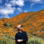 Kenneth Mitchell Instagram - Marinating in the wonderment of the Poppy Super Blooms with my #StarTrek buddy @couttsemily #LLAP #StarTrekDiscovery 🧡 Walker Canyon Poppy Fields