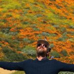 Kenneth Mitchell Instagram - Marinating in the wonderment of the Poppy Super Blooms with my #StarTrek buddy @couttsemily #LLAP #StarTrekDiscovery 🧡 Walker Canyon Poppy Fields