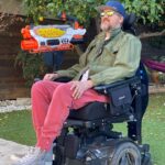 Kenneth Mitchell Instagram - NERF battle ready. {VIDEO} custom adaptive nerf blaster made accessible with a knee switch. Making lemonade from all these Lemons. This Life is a gift. Carpe Diem 🍋🍋🍋 #ALS #nerf California