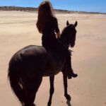 Kerri Kasem Instagram – Wishing you love and wishing the world peace. 🤍🌏🕊️

@my_cavago 
#Beach #Horses #Portugal