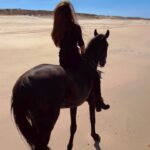 Kerri Kasem Instagram - Wishing you love and wishing the world peace. 🤍🌏🕊️ @my_cavago #Beach #Horses #Portugal
