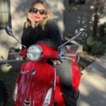 Kristen Bell Instagram - I said, “I don’t like motorcycles they’re too loud.“ He said, “oh yeah, well this one is electric.“ I said, “it would have to match my lipstick.“ He said, “BOOM!” I said, “Fine. Let’s ride, bitch.” @vespa @red